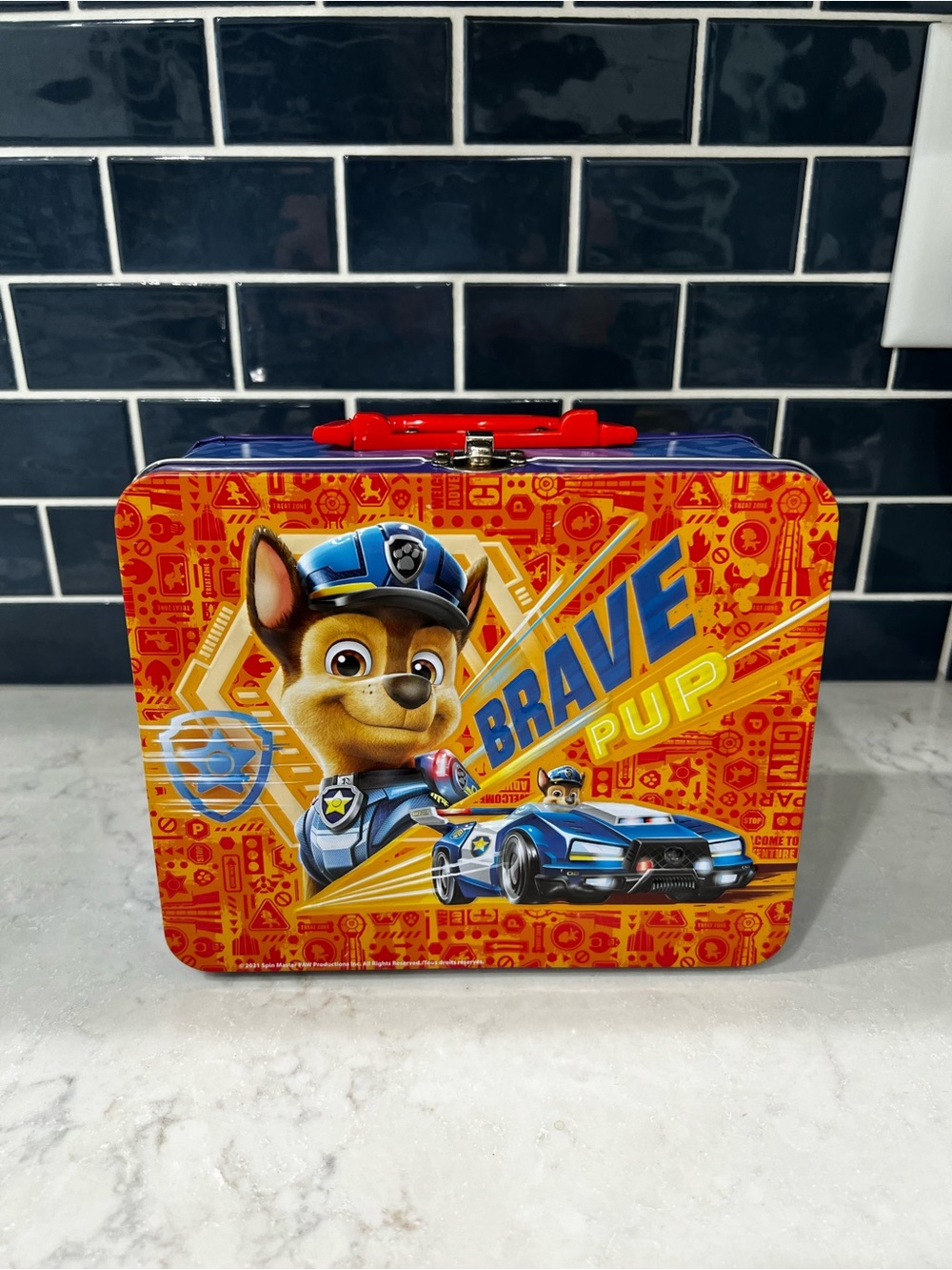 Paw Patrol Brave Pup Tin Box and 5 Paw Patrol trucks.